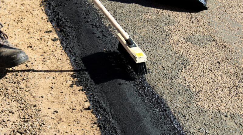 workers putting concrete on the road